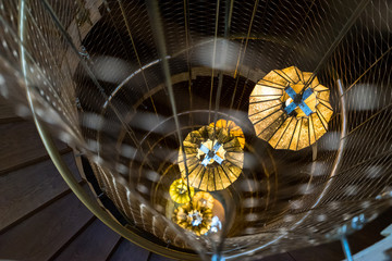 Spiral Staircase with Lantern Lamps. Moern staircase lit by design lantern lamps, taken in a old building in Barcelona, Spain.