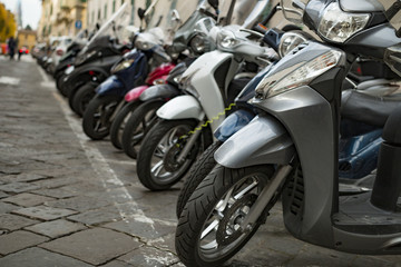 Fototapeta na wymiar Scooters parked on a city street. Italy. Florence.