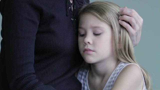 sad daughter hugging his mother at home. Concept of couple family is in sorrow.