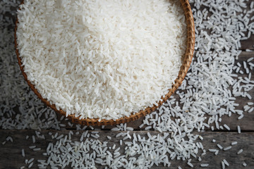 Mix size jasmine rice on the wood background