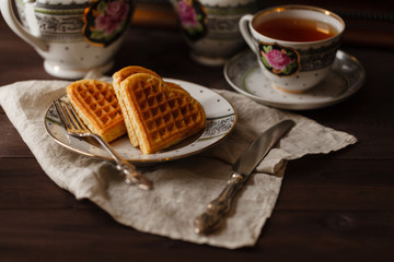 Viennese wafers on dark table with tea cup