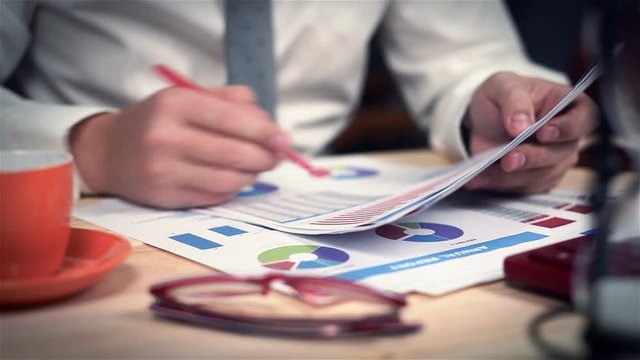 Businessman Sitting In Office And Monitoring Stock Statistics. Close Up