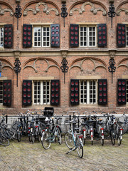 Fototapeta na wymiar Dutch architectural façade. A traditional old building in the Dutch city of Nijmegen, Netherlands, fronted by bicycles.