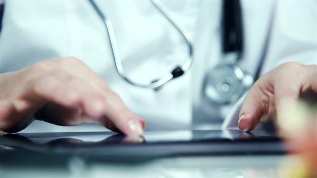 Doctor Woman Using Digital Tablet. Close Up