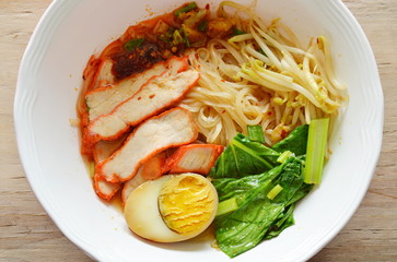 thin rice noodle topping slice red barbecue pork and brown egg in soup
