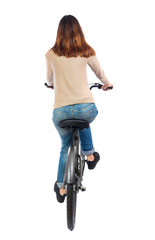 back view of a woman with a bicycle. cyclist sits on the bike. Rear view people collection.  backside view of person. Isolated over white background. Brunette pedaling a bicycle.
