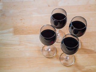 four glasses of red wine on a table