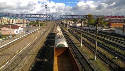 Fototapeta na wymiar Freight train moving slowly on the station. The view from the top