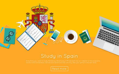 Study in Spain concept for your web banner or print materials. Top view of a laptop, books and coffee cup on national flag. Flat style study abroad website header.
