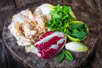Fresh colorful  lettuce on wooden background