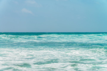 Fototapeta na wymiar Sunny beach near Koggala - Sri Lanka. Waves of clear water and warm sand 