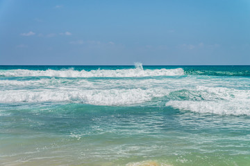 Sunny beach near Koggala - Sri Lanka. Waves of clear water and warm sand 