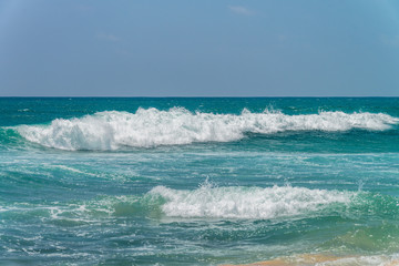 Sunny beach near Koggala - Sri Lanka. Waves of clear water and warm sand 