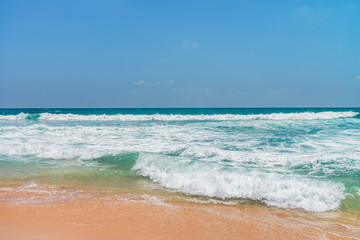 Obraz na płótnie Canvas Sunny beach near Koggala - Sri Lanka. Waves of clear water and warm sand 
