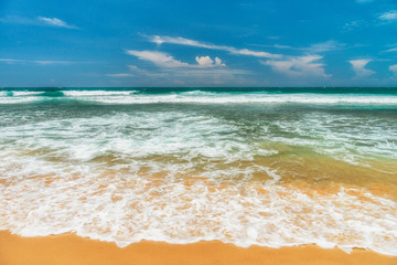 Sunny beach near Koggala - Sri Lanka. Waves of clear water and warm sand 