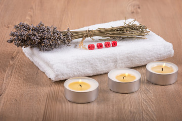 Obraz na płótnie Canvas Spa decoration / Still life with dry lavender, candles, towel and love written on wooden blocks on a wooden background 