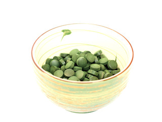 spirulina in a bowl on a white background