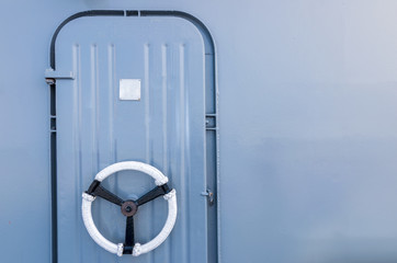 metal door on the ship, blue background, wallpaper of the door