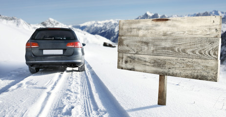 winter road and car with road sign 