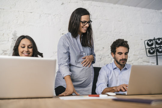 Young team of coworkers doing a meeting in a modern studio