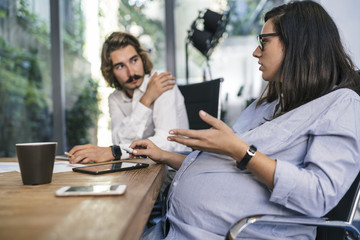 Young team of coworkers doing a meeting in a modern studio