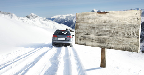 Fototapeta premium winter road and car with road sign 