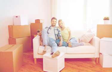 Fototapeta na wymiar happy couple with big cardboard boxes at new home