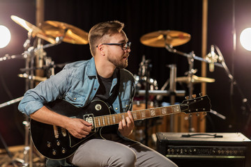 man playing guitar at studio rehearsal