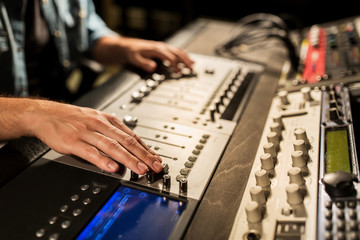 Fototapeta na wymiar man using mixing console in music recording studio
