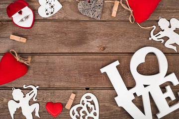Valentines day ring and handmaded hearts over wooden table.