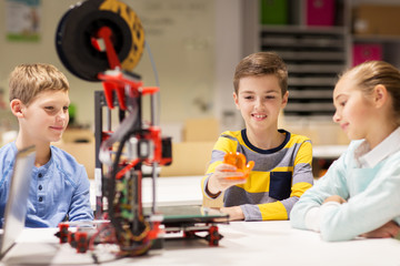 happy children with 3d printer at robotics school