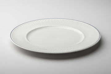 Empty round white plate with decorated border