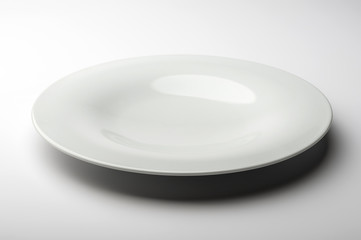 Empty round white plate with smooth edge