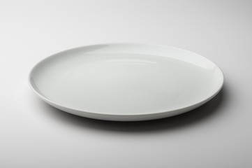 Empty round white plate with smooth edge