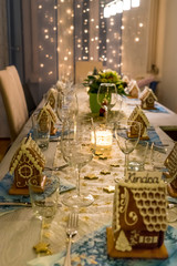 Christmas Dinner Table with Gingerbread Houses Place Cards. Beautifully decoreted christmas dinner table with hand made gingerbread houses as place cards.