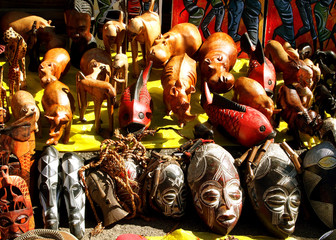 African wooden and stone souvenirs masks and wild animals. Local market. South Africa.