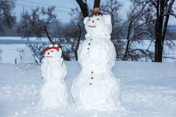 two snowman on a park