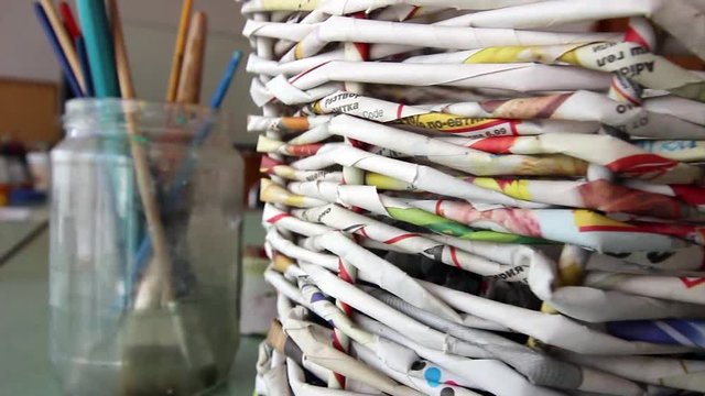 Handmade basket made of from old newspapers - recycle conception, hd video