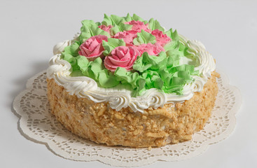 The cake is decorated with cream on a white napkin.