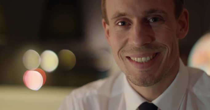 Executive business man in white shirt looking at camera and smiling positive