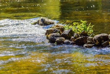 Fototapeta na wymiar The river flows over the rocks.