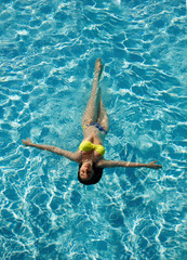 Sexy
tanned woman in pool water bikini model
