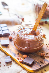 Raw Vegan Healthy Hazelnut and Chocolate Cream on Light Wooden Table, Vertical View