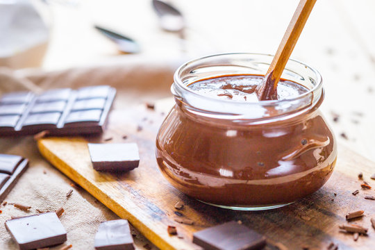 Homemade Paleo Nutella Cream In Glass Jar With Hazelnuts And Dark Chocolate, Horizontal View