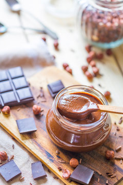 Homemade Chocolate Hazelnut Nutella on Light Rustic Wooden Background, Vertical View