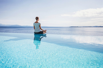 Young woman practicing yoga outdoors. Relaxation harmony lifestyle concept