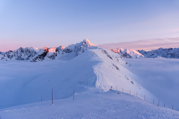 Big mountain peaks at sunset and inversion.