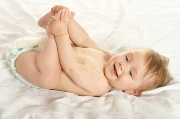 Fototapeta na wymiar Baby girl lying in pampers