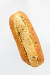 oval bread on a white background top view. European bread loaf of wheat flour with the addition of olive slices.