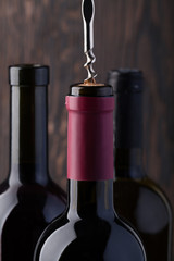 Bottle of red wine and corkscrew